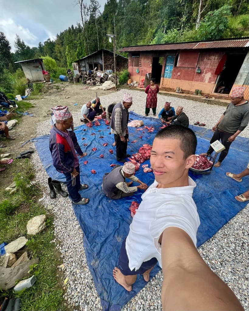 Partaking in buffalo butchering in rural Nepal