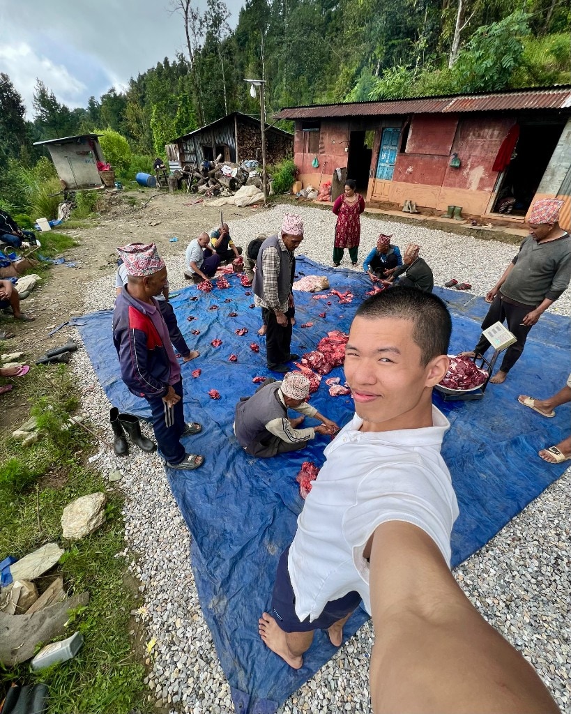 Partaking in buffalo butchering in rural Nepal